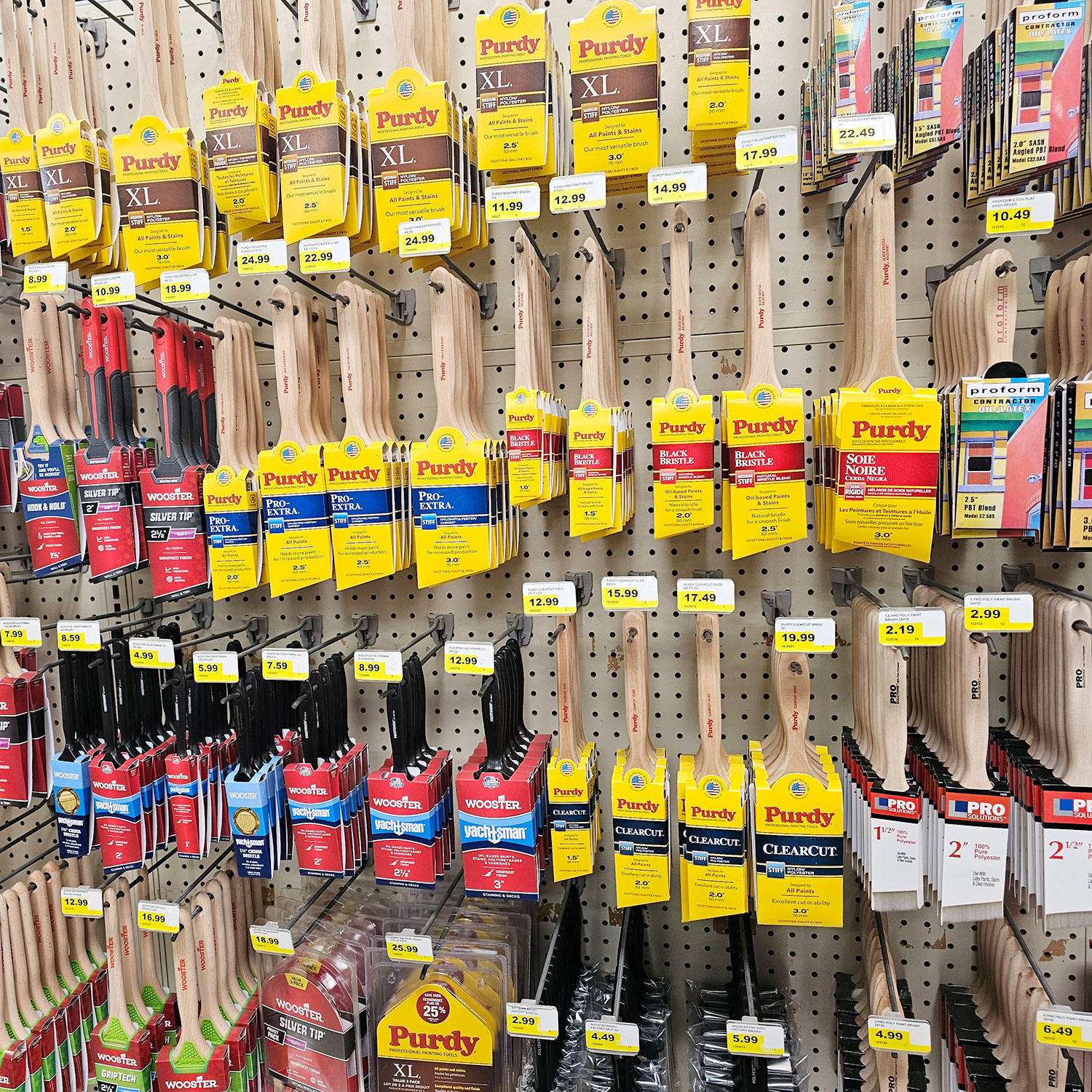 Paint brushes hanging on peg hooks