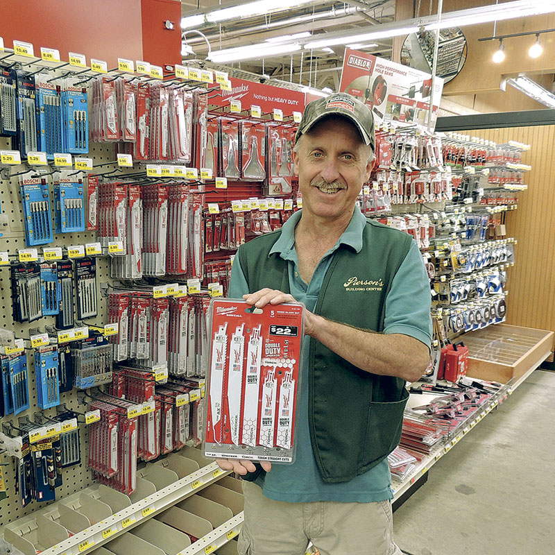 Employee holding reciprocal saw blades